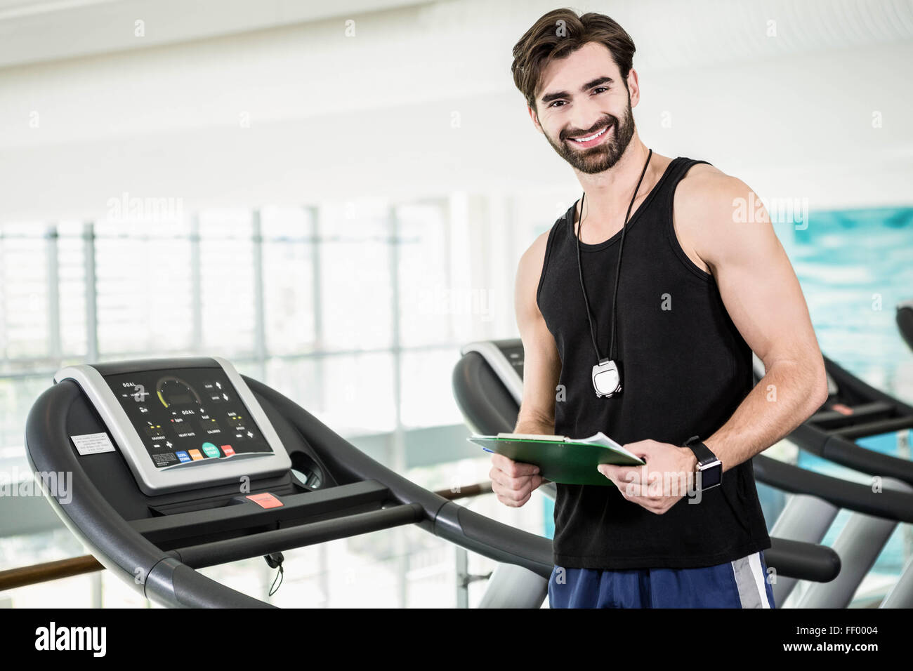 Smiling trainer holding clipboard Stock Photo