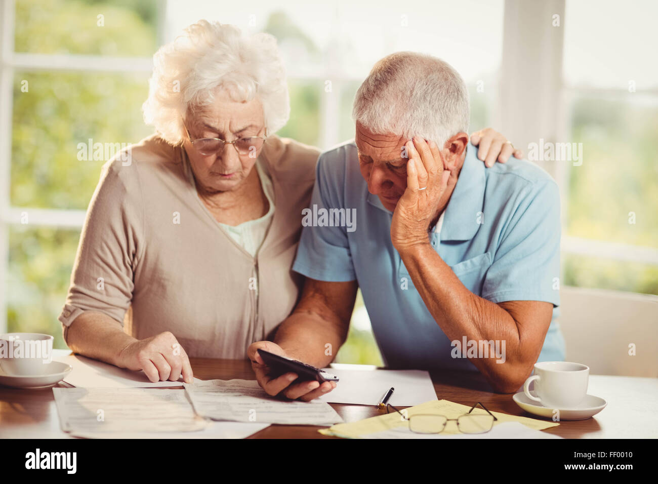 Senior couple counting bills Stock Photo