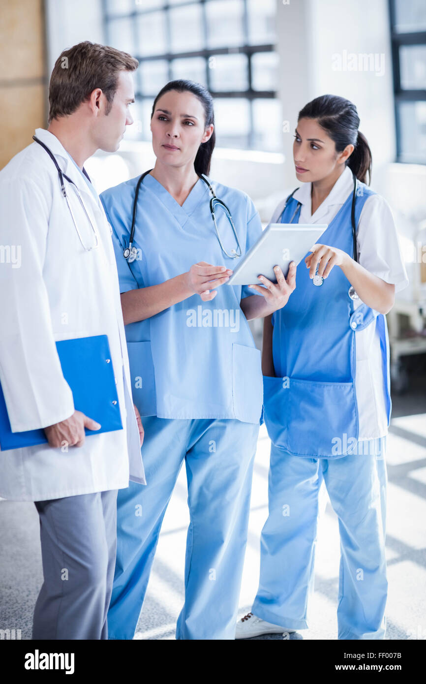 Medical team looking at tablet pc Stock Photo