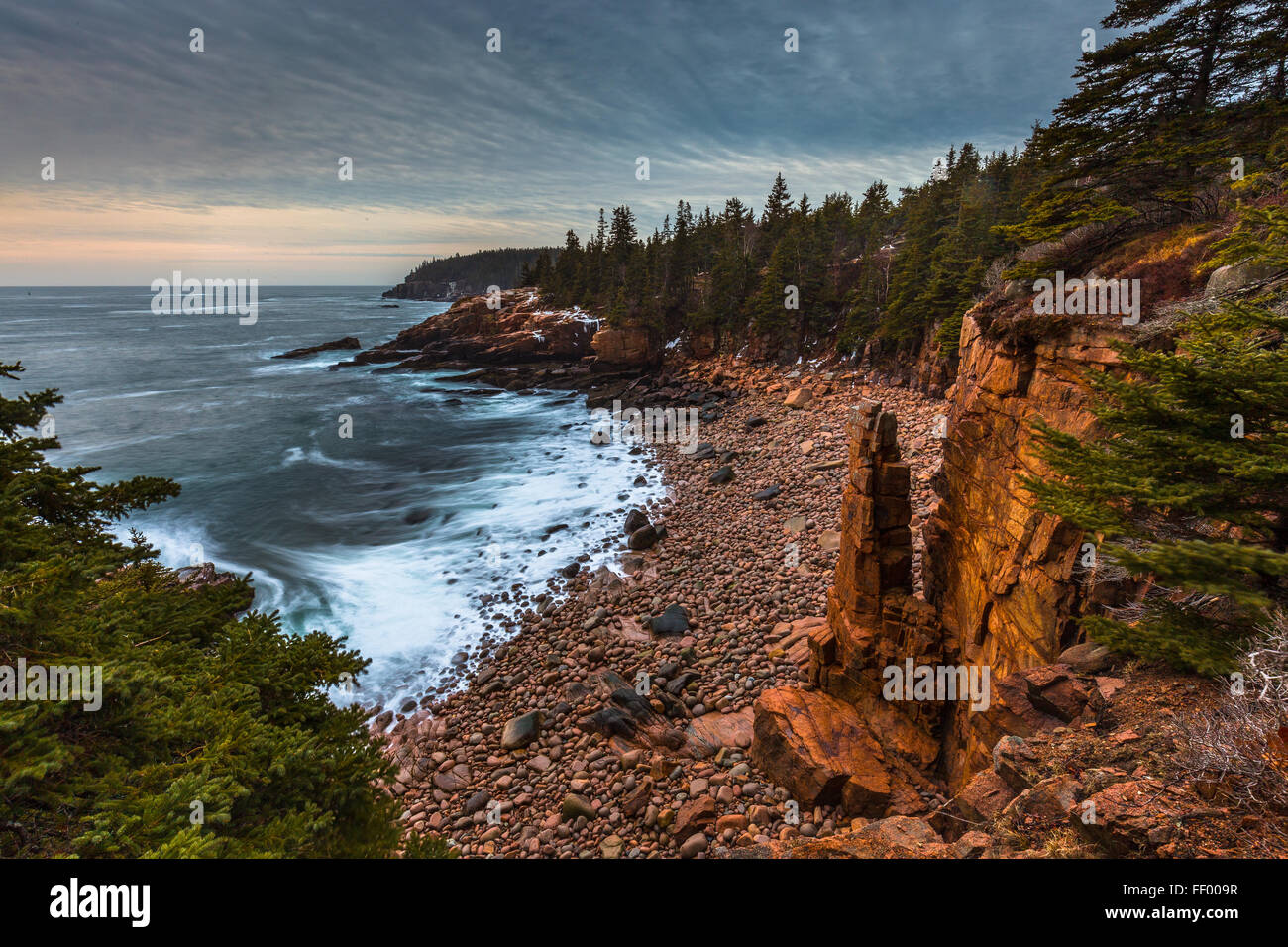 Swilrling surf breaking on the shore of Monument Cove in Acadia National Park, Mount Desert Island, Maine, New England, USA. Stock Photo