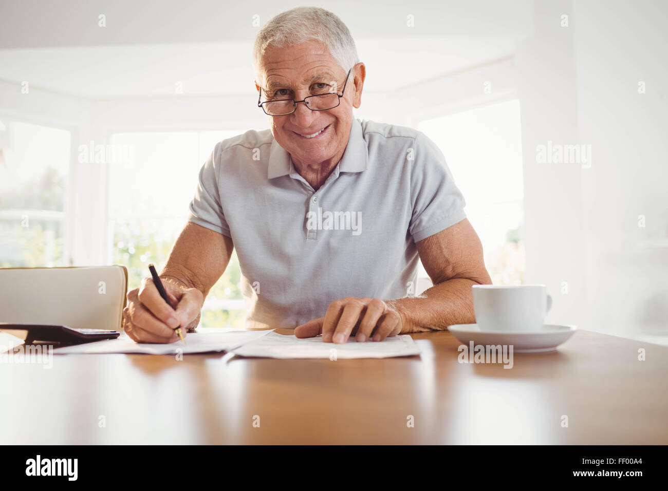 Worried senior man with tax documents Stock Photo