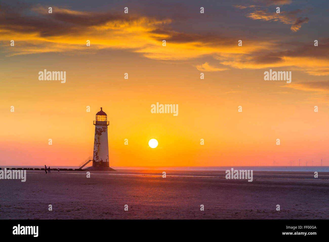 Talacre beach and the Point of Ayr Lighthouse at sunset. Stock Photo