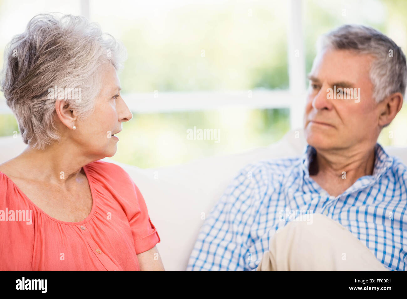 Senior couple having argument on the sofa Stock Photo - Alamy