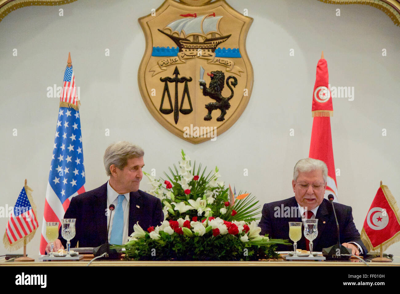 Secretary Kerry Listens to Foreign Minister Baccouche Speak after Signing Agreement at the Ministry of Foreign Affairs in Tunis Stock Photo