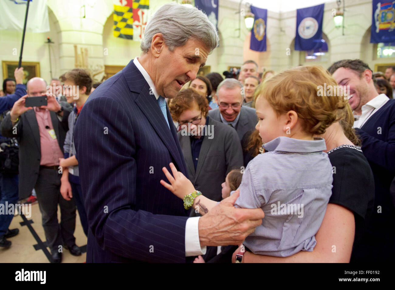 Secretary Kerry Embraces a Child After Addressing Members of U.S. Embassy France and the U.S. Missions to UNESCO and OECD in Paris Stock Photo