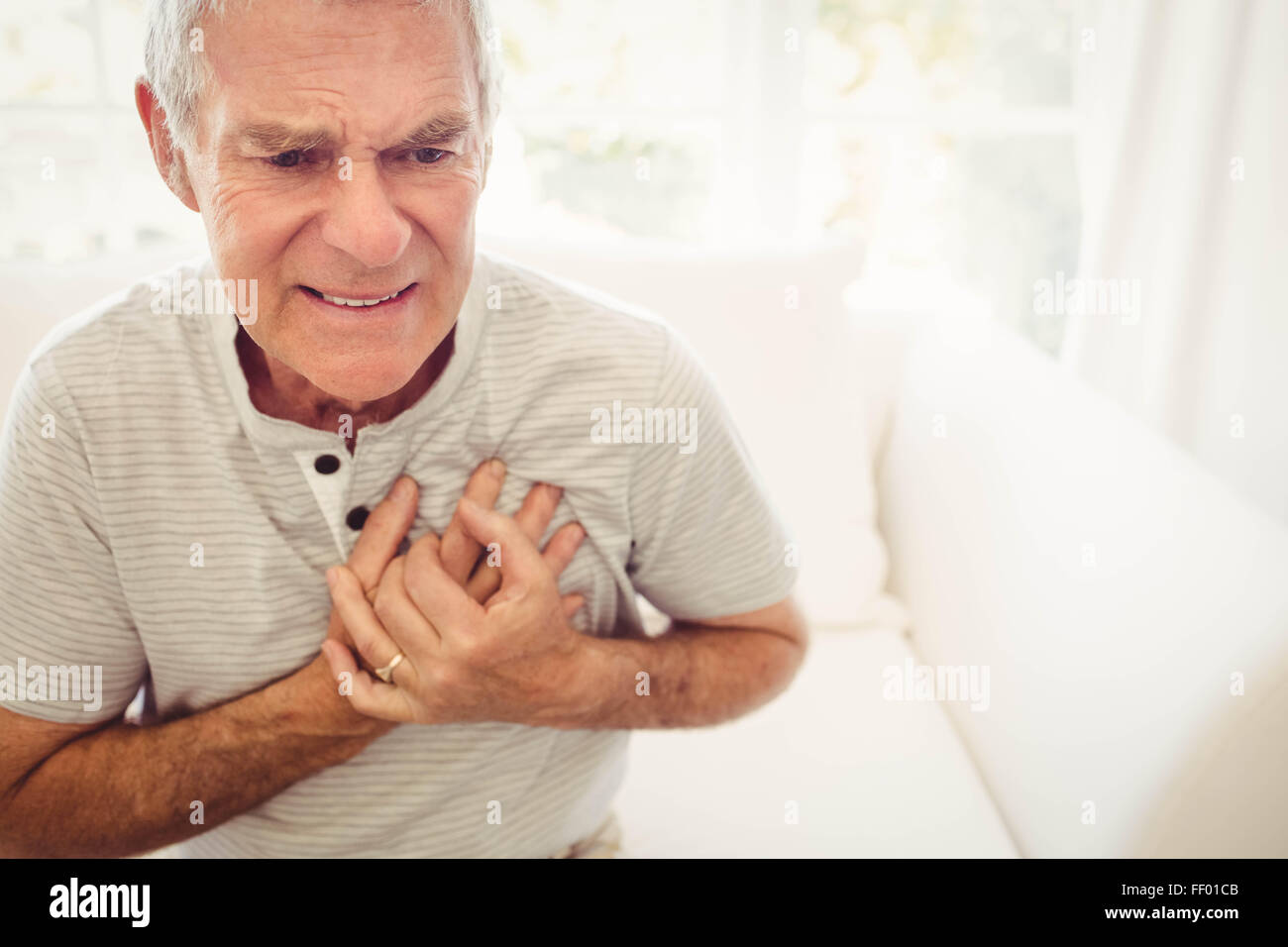 Senior man with pain on heart Stock Photo