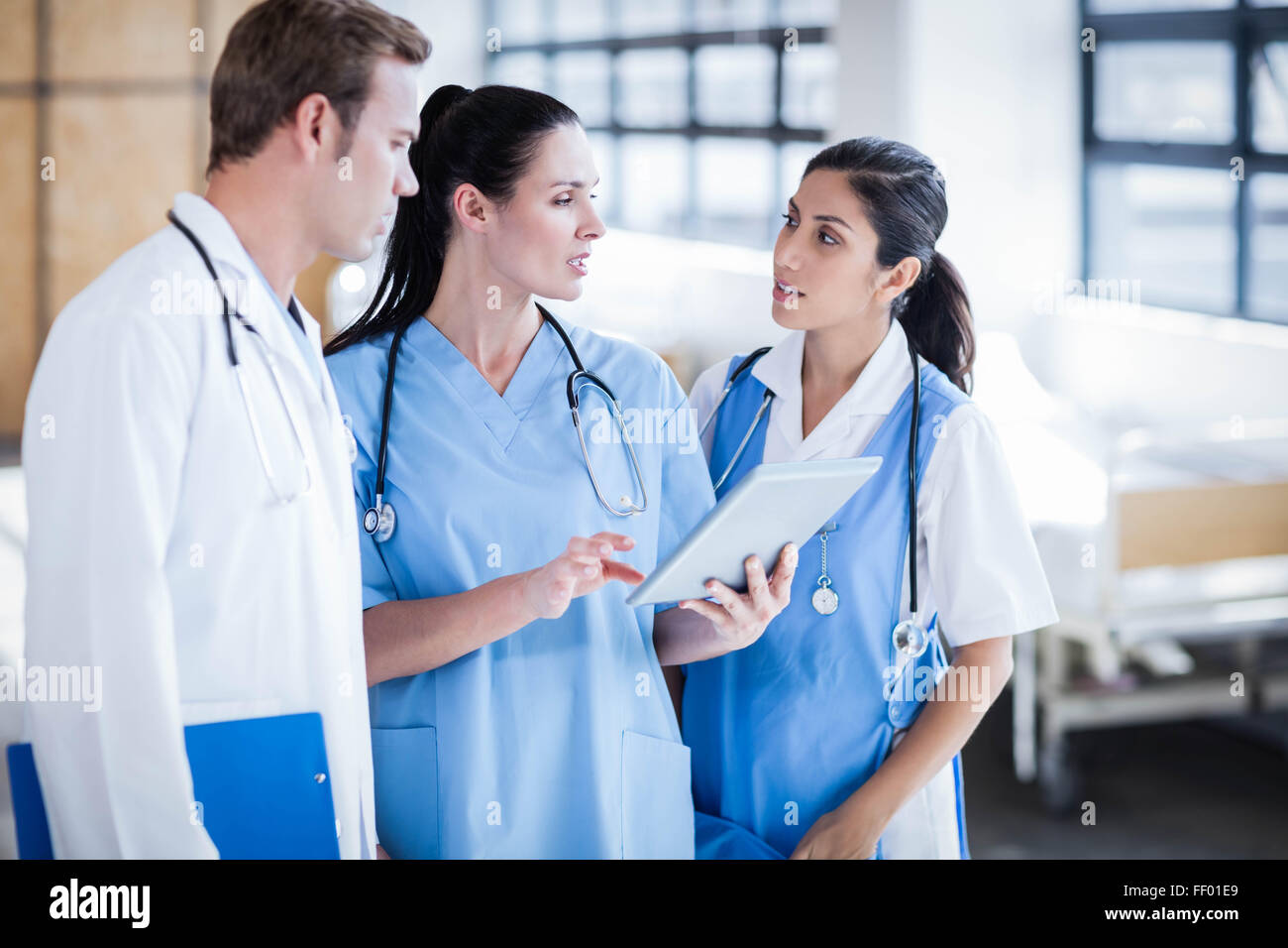 Medical team looking at tablet pc Stock Photo