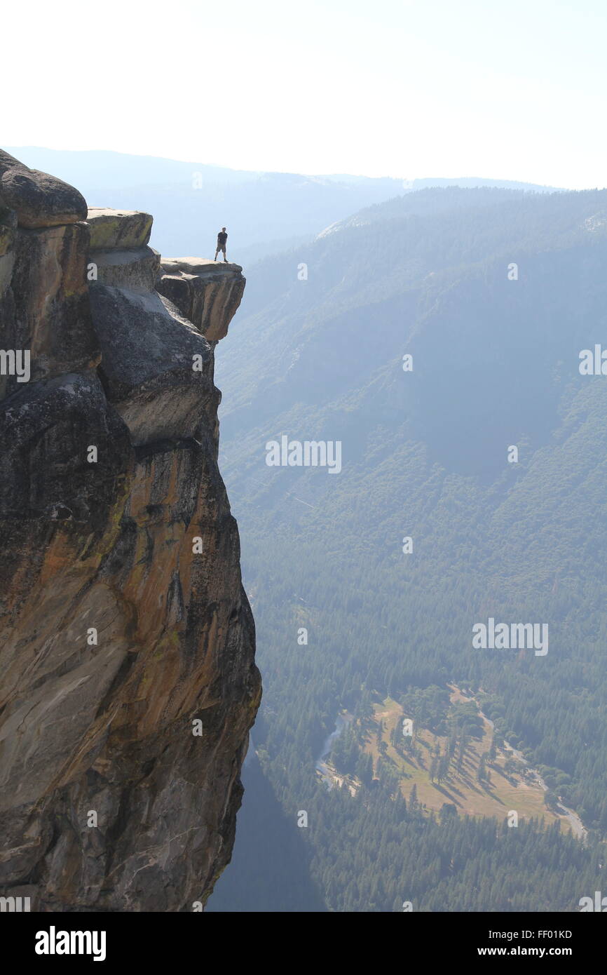 Lone figure on a outjet of rock Stock Photo