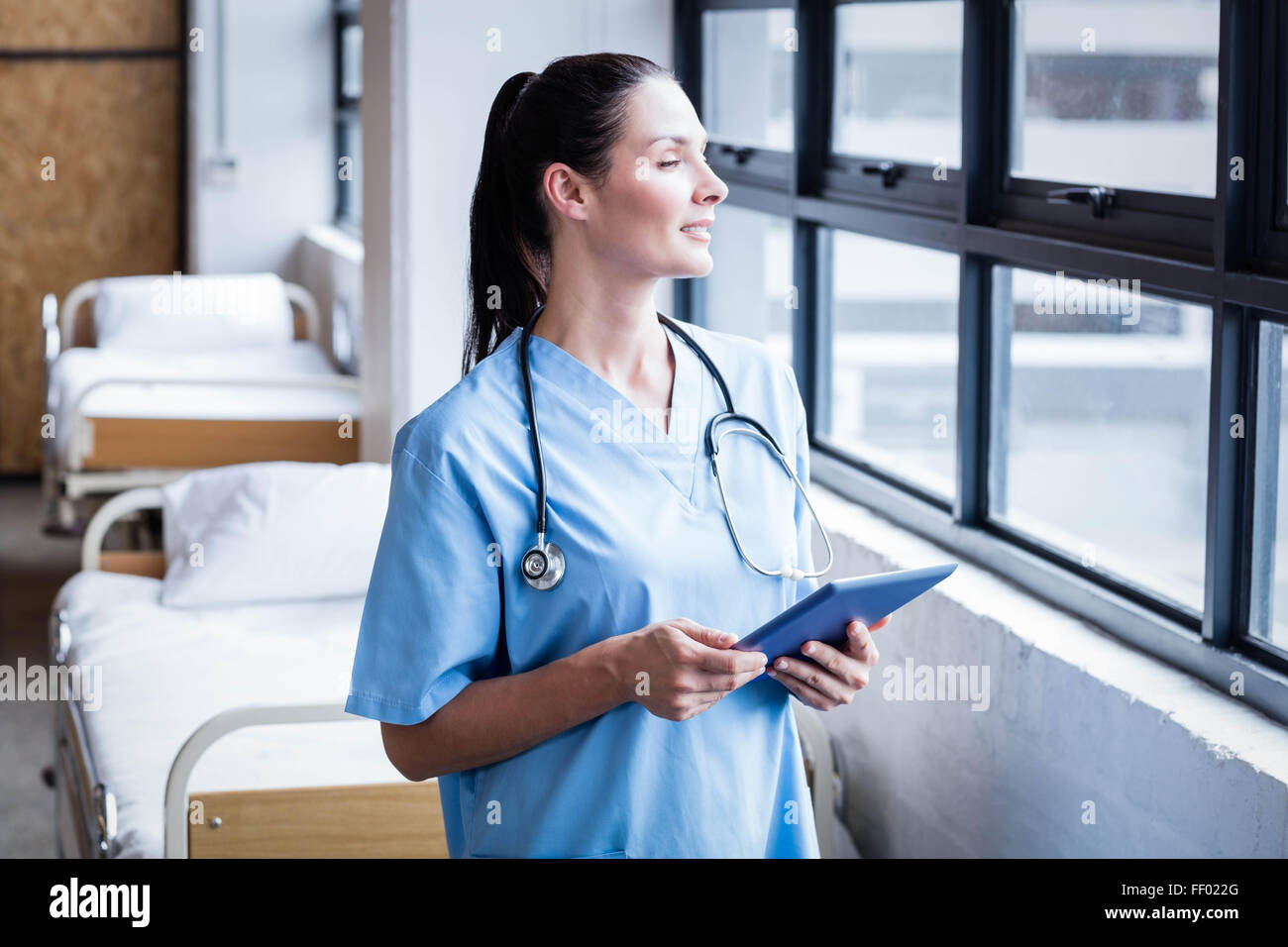 Nurse using her tablet pc Stock Photo