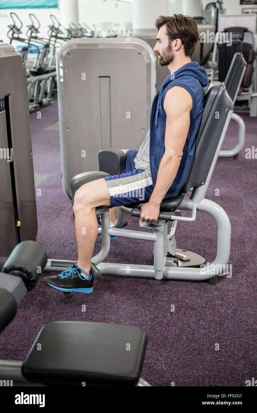 Focused man using weights machine for legs Stock Photo Alamy