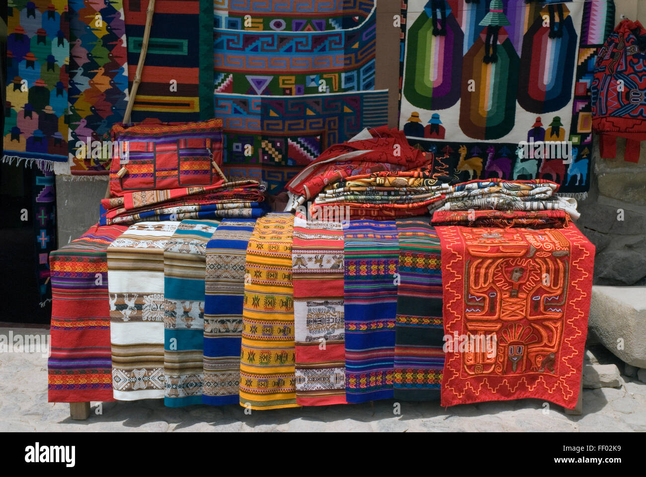 Peru, Ollantaytambo, traditional, patterned fabrics on display at market stall Stock Photo