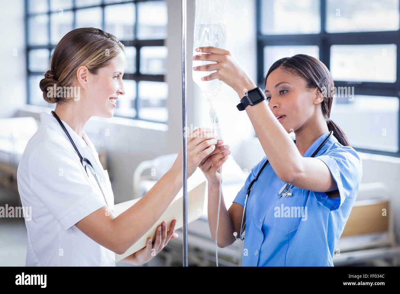 Medical team preparing an IV drip Stock Photo