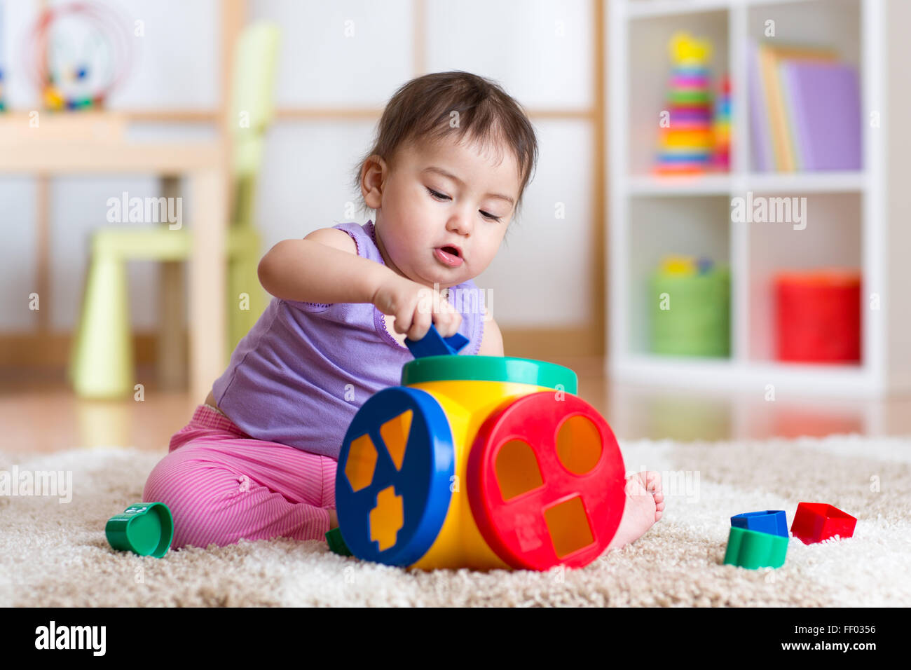 kid girl plays with educational toy indoor Stock Photo Alamy