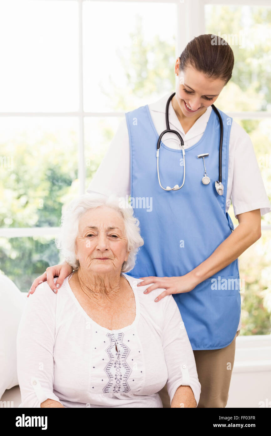 Nurse taking care of sick elderly woman Stock Photo
