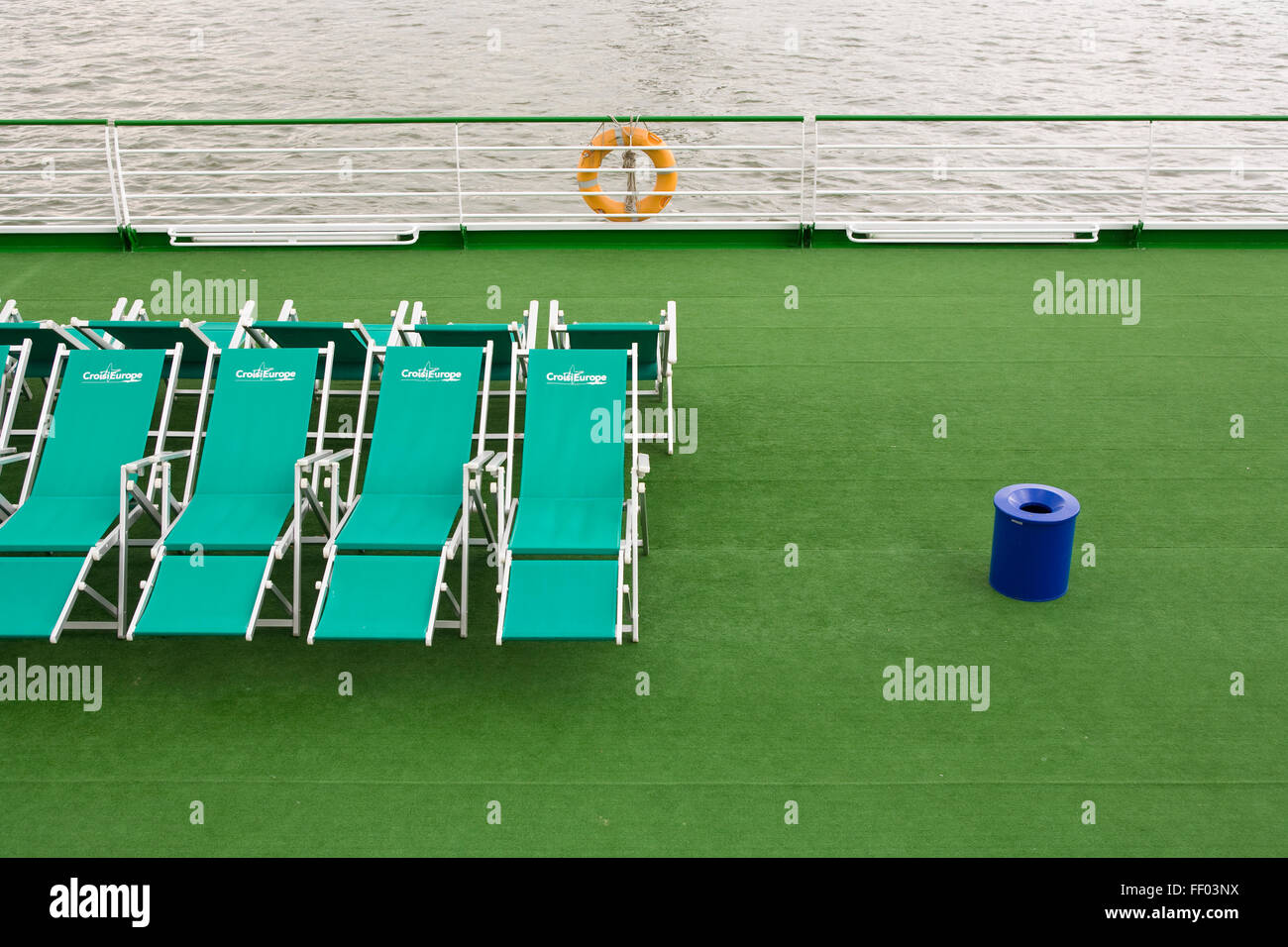 Europe, Germany, Cologne, sunloungers and trash can on the deck of a ship at the banks of the river Rhine.  Europa, Deutschland, Stock Photo