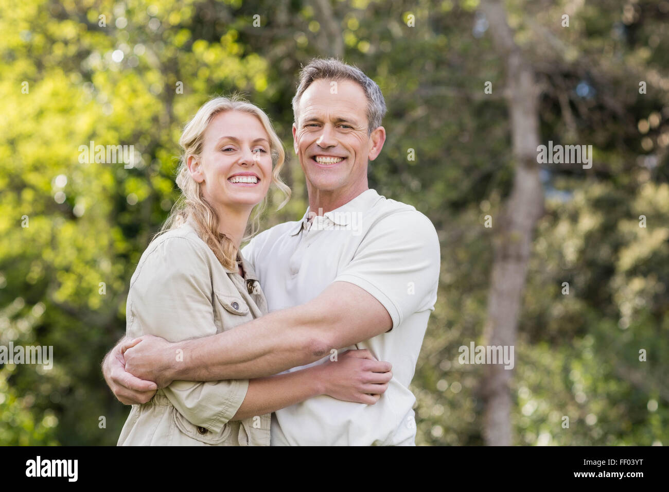 Cute couple hugging with arms around Stock Photo
