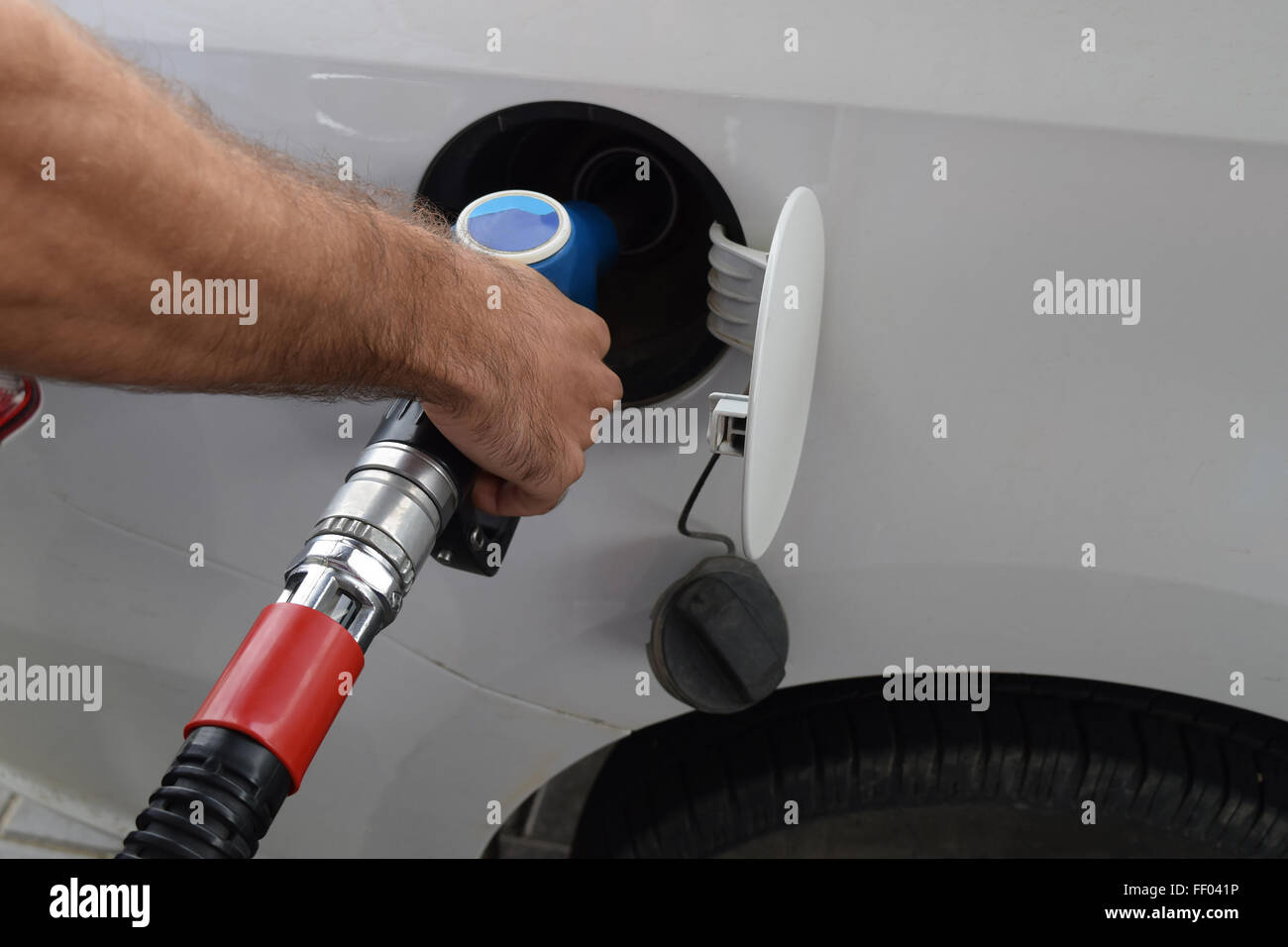 Filling with car gasoline. Service on a gas station Stock Photo - Alamy