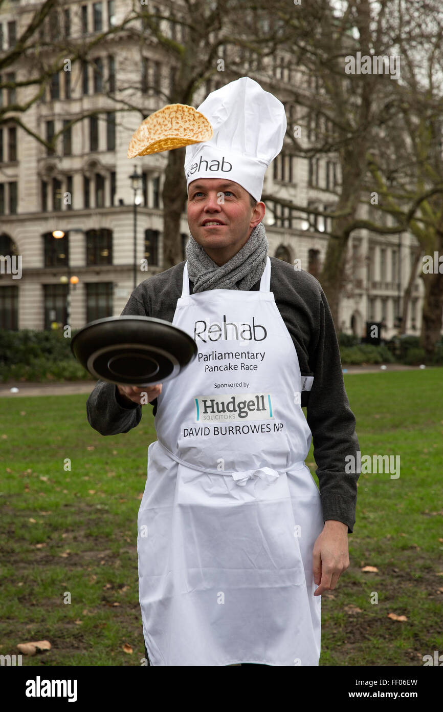 Westminster,UK,9th February 2016,David burroes MP tosses a pancake at the Rehab Parliamentary Pancake Race 201 Credit: Keith Larby/Alamy Live News Stock Photo