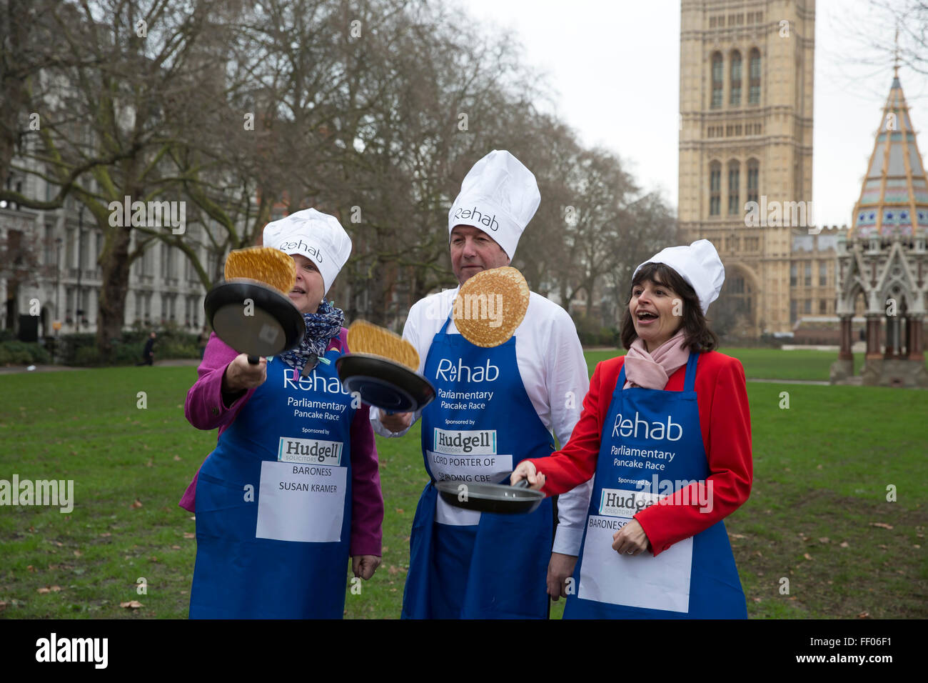 Westminster,UK,9th February 2016,Baroness Susan Kramer, Lord Porter of Spalding and Baroness Parminter toss pancakes at the Rehab Parliamentary Pancake Race 201 Credit: Keith Larby/Alamy Live News Stock Photo