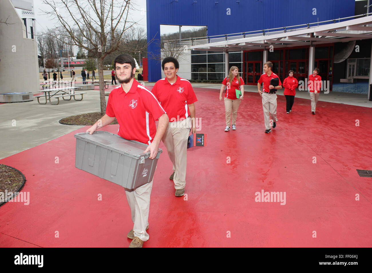 Teams depart from the FIRST Robotics kick-off event with their kits of parts, preparing for an upcoming robotics competition. Stock Photo