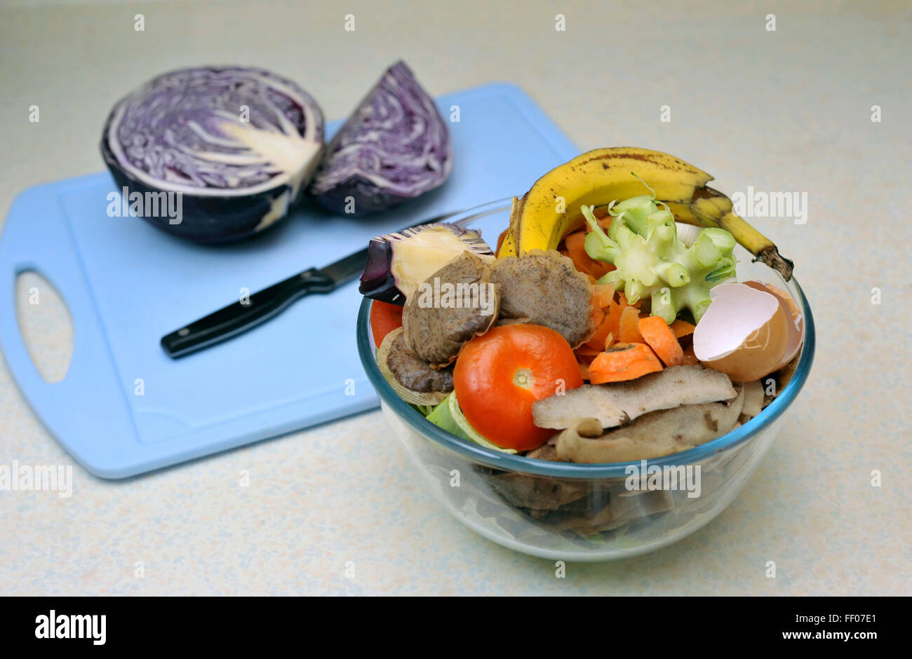 Vegetable food waste collected for composting, beside red cabbage being