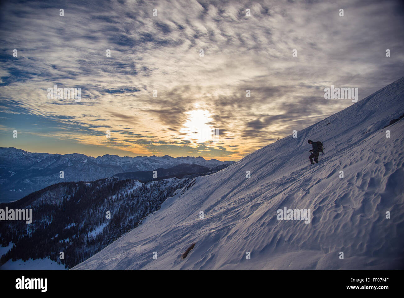 Mountain Climber on Icy Mountainside Mountain Climber on Icy Mountainside Stock Photo