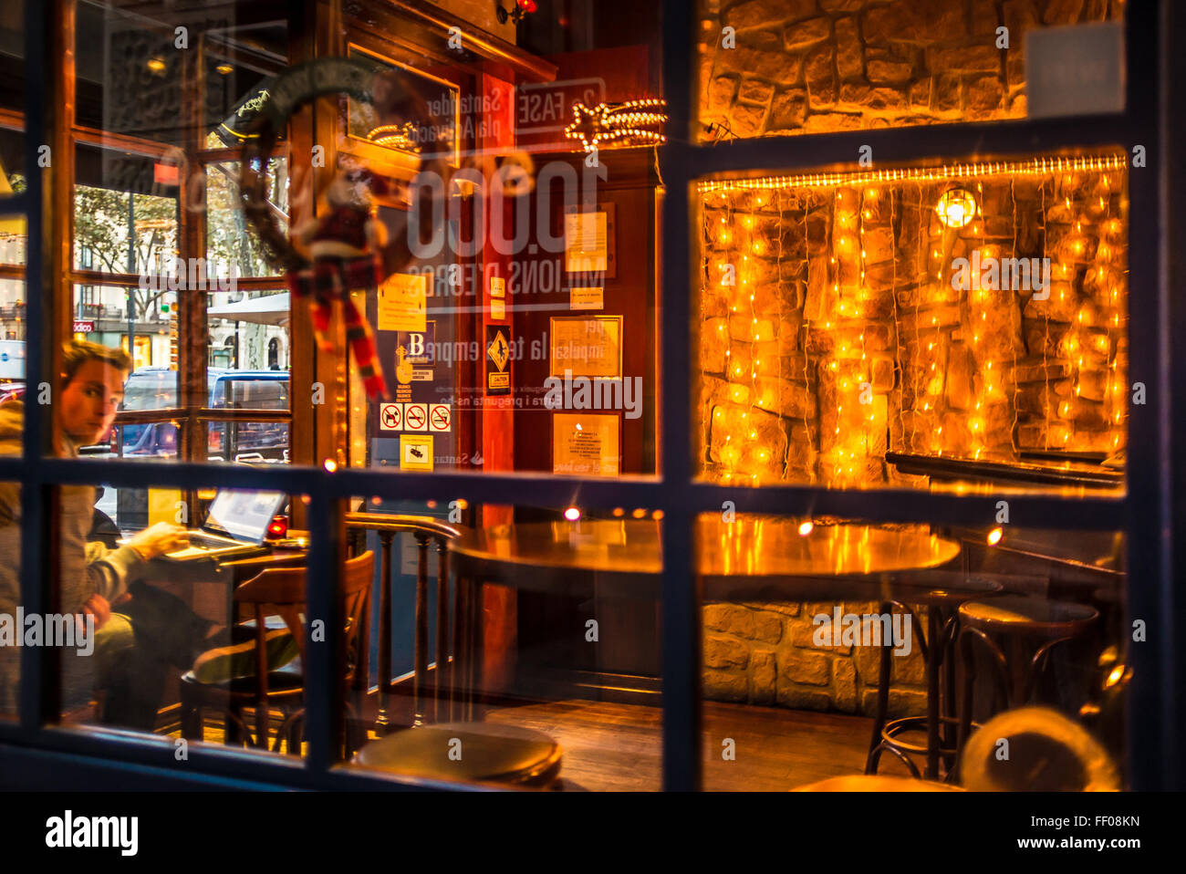 A cozy cafe scene featuring a window with multiple panes, a bar stool ...