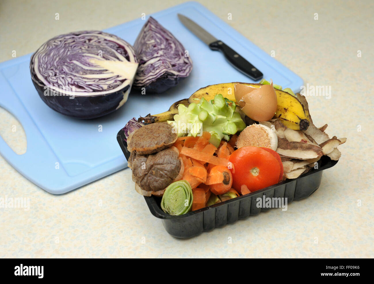 Vegetable food waste collected in a reused container for composting