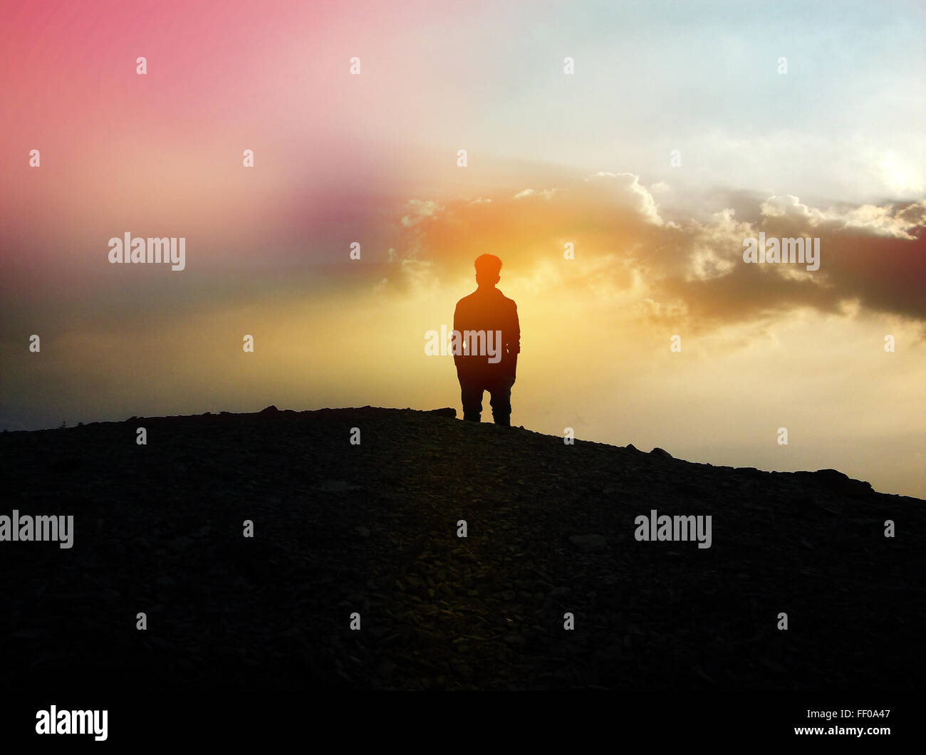 Silhouette of Person Viewing Colorful Sky Silhouette of Person Viewing Colorful Sky Stock Photo