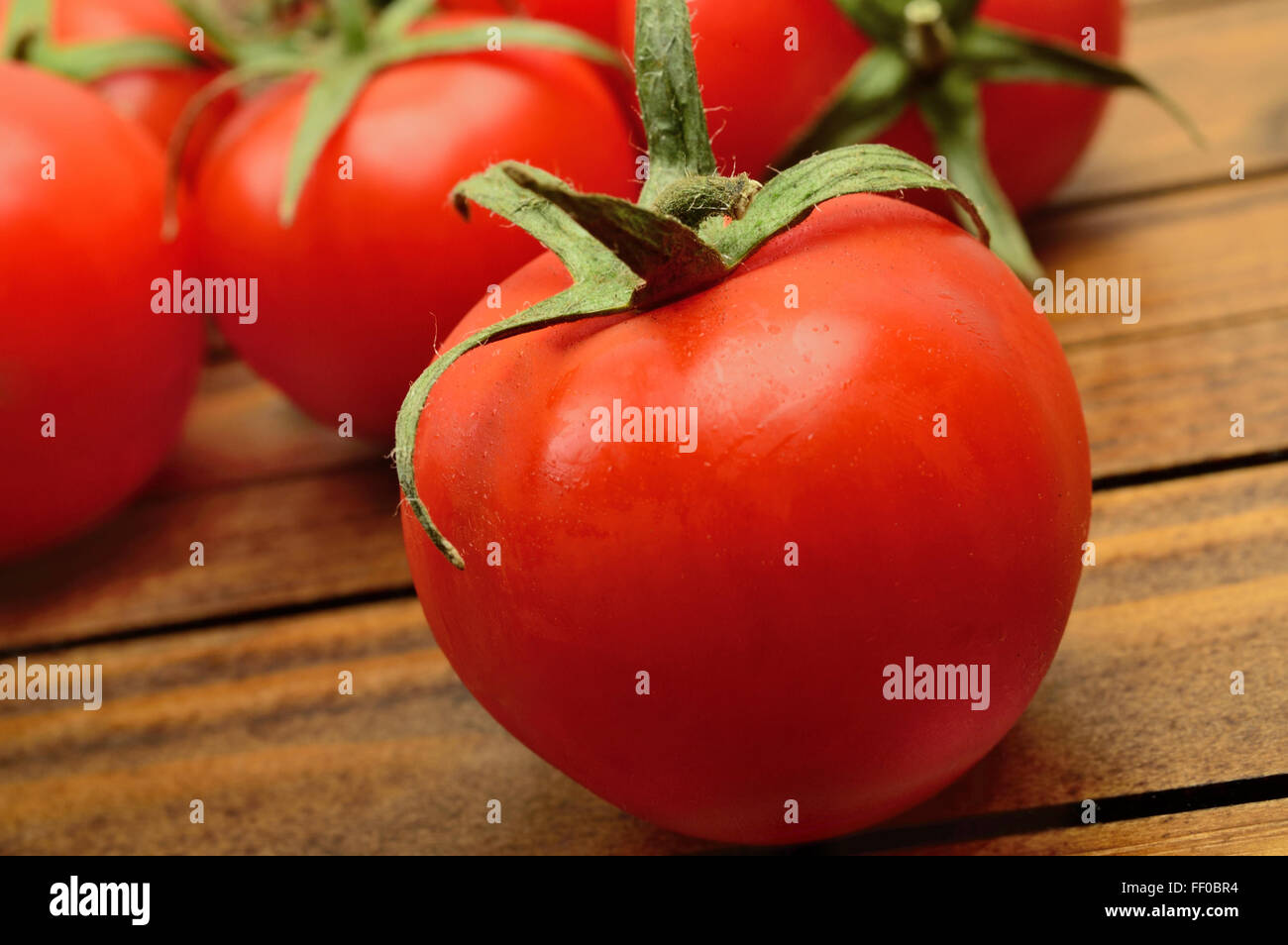 Group of tomatoes on wooden table Stock Photo