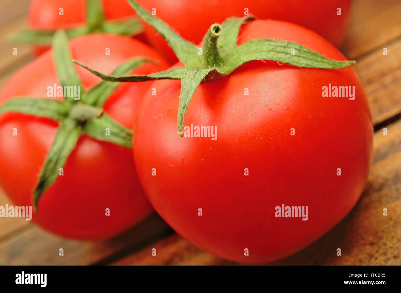 Closeup Tomatoes on wooden table Stock Photo