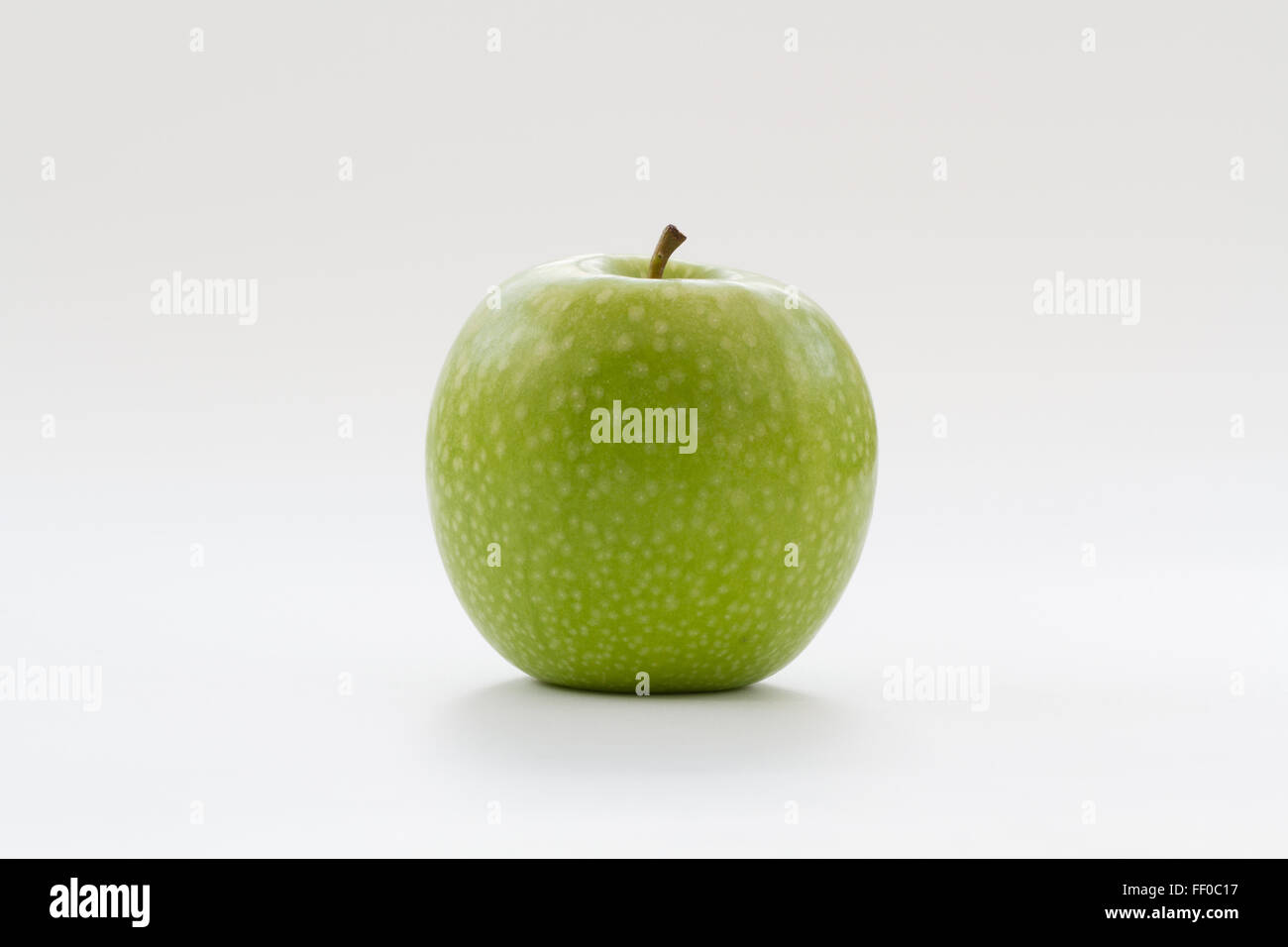 A fresh, green apple on an isolated white background. Stock Photo