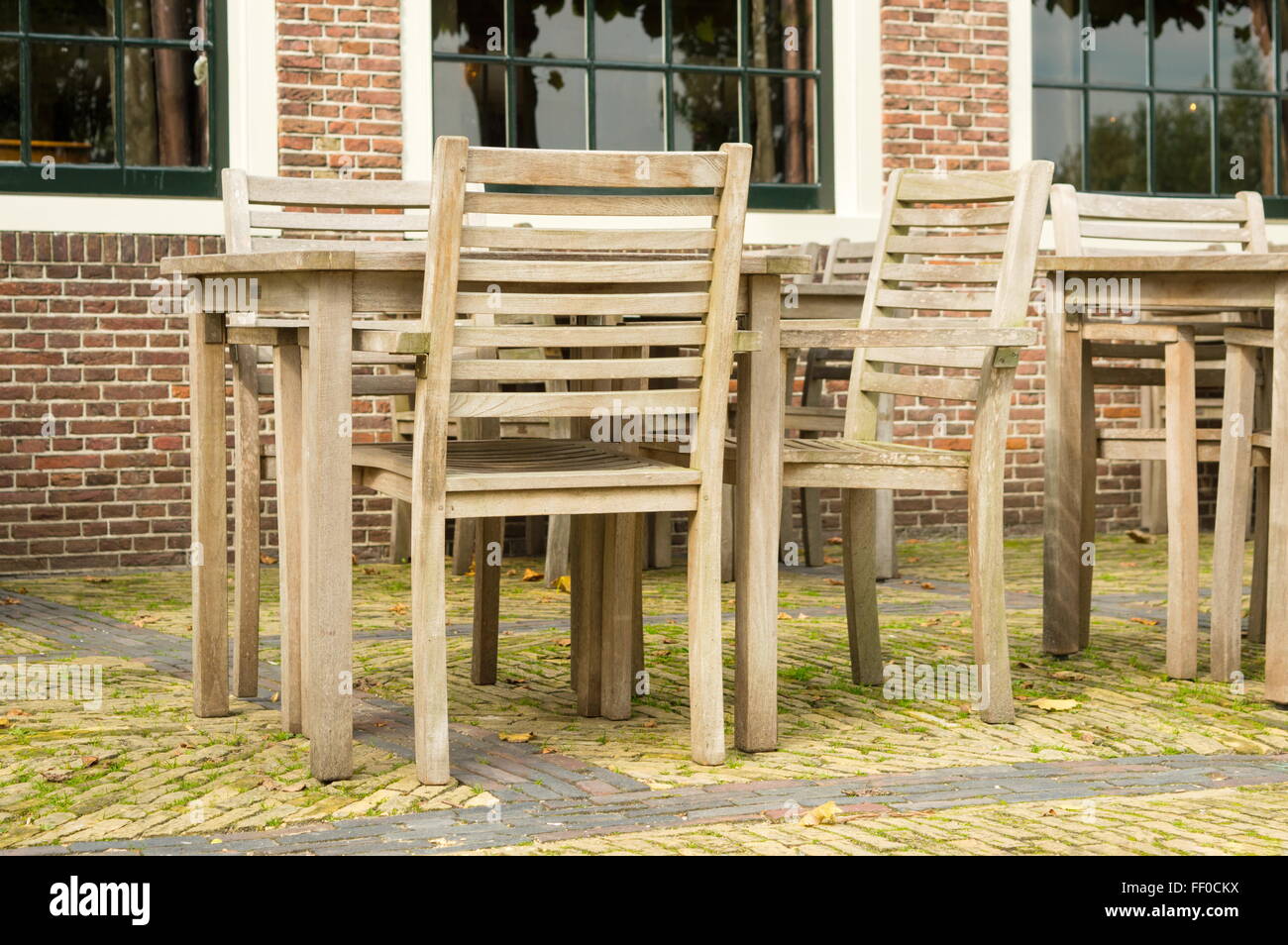 set of wooden table and chairs outside Stock Photo