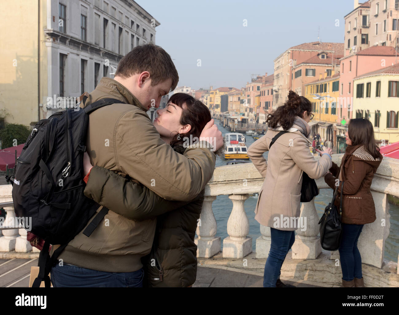 A coupe embrace on a Venice bridge during carnival Stock Photo