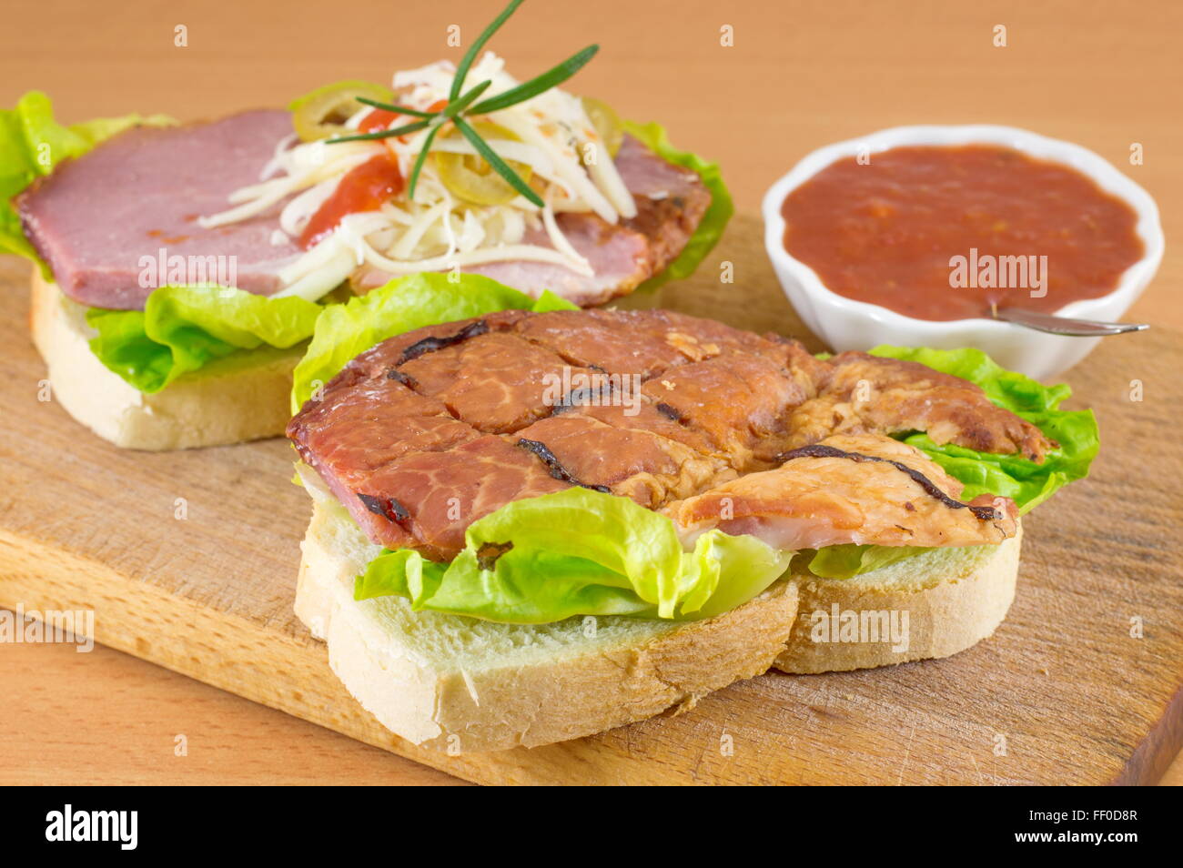 the making of a double sandwich on a cutting board Stock Photo Alamy