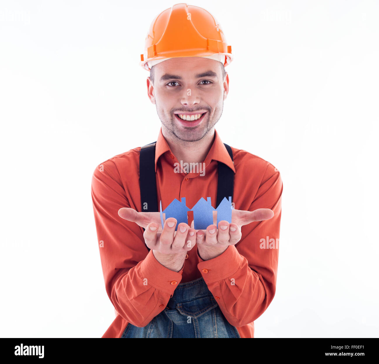 Contruction Paper Man A builder man holding paper houses Stock Photo - Alamy