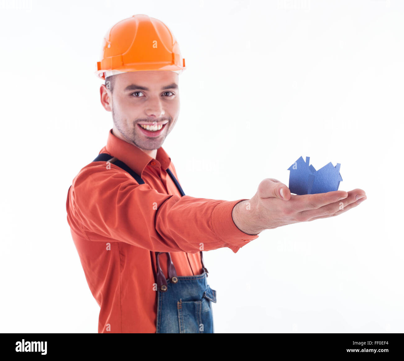 Contruction Paper Man A builder man holding a paper house Stock Photo - Alamy