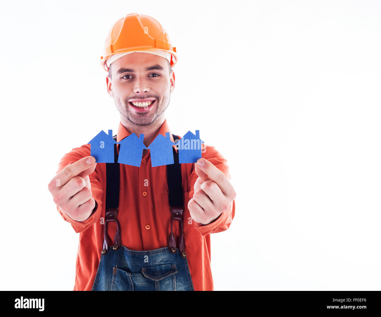 Contruction Paper Man A builder man holding paper houses Stock Photo - Alamy