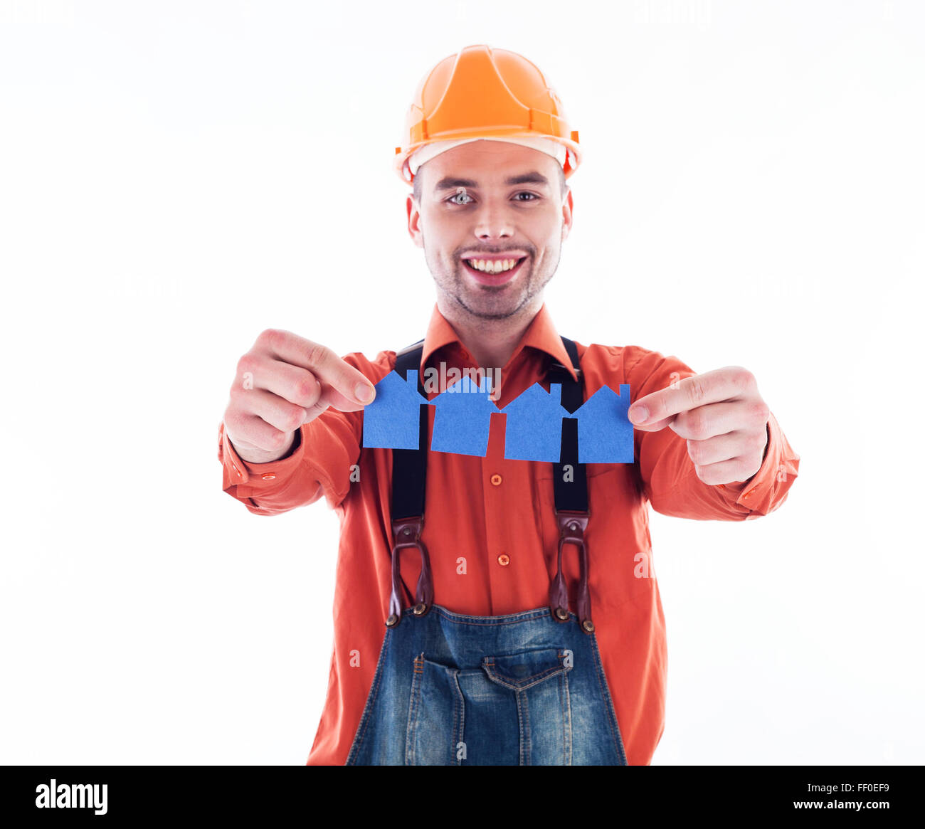 Contruction Paper Man A builder man holding paper houses Stock Photo - Alamy