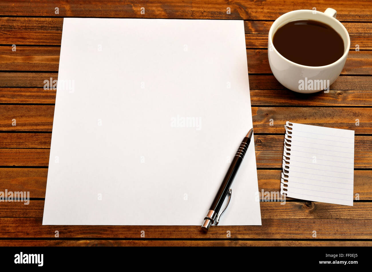 Empty paper with cup of coffee on desk Stock Photo