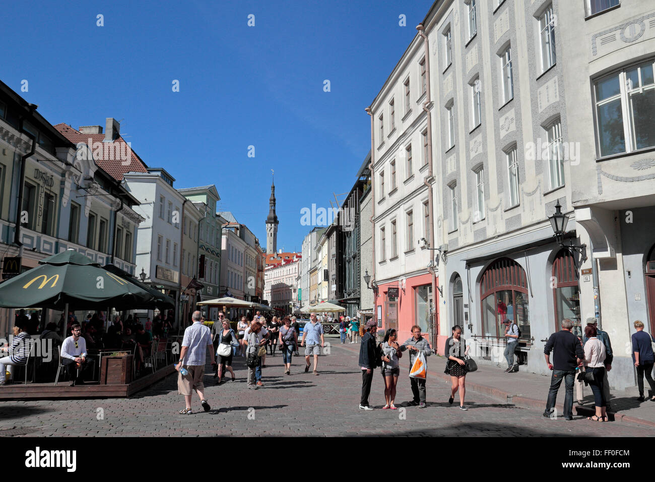 General street view (looking up Viru) of a shopping street in Tallinn, Estonia (the distant tower belongs to Tallinn Town Hall). Stock Photo