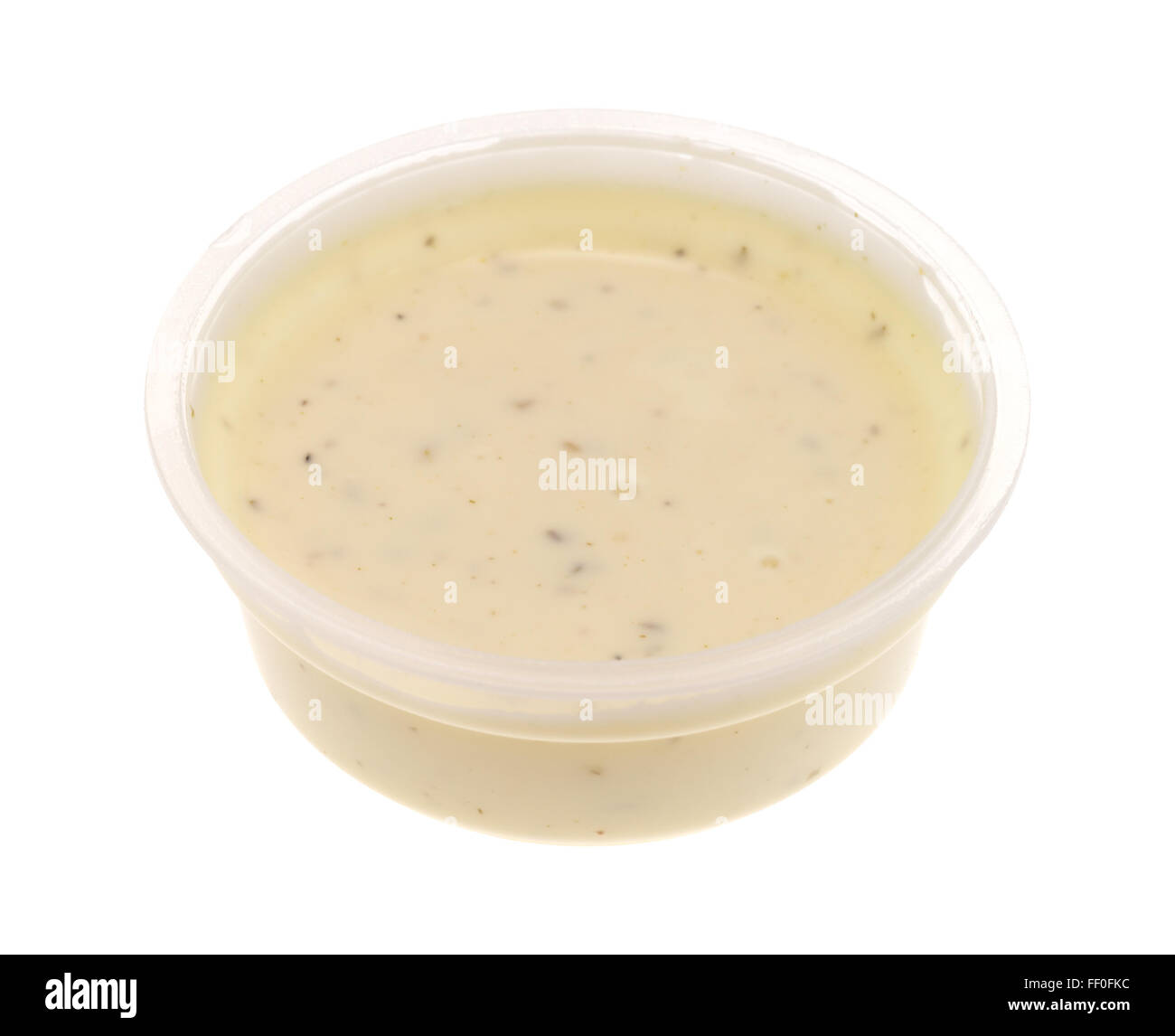 Side view of a small plastic container of ranch dressing isolated on a