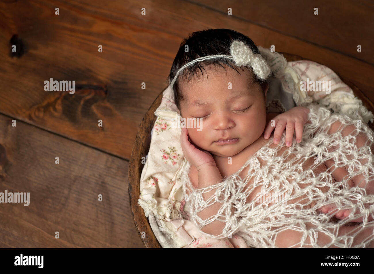 Newborn Baby Girl Sleeping in a Fetal Position Stock Photo