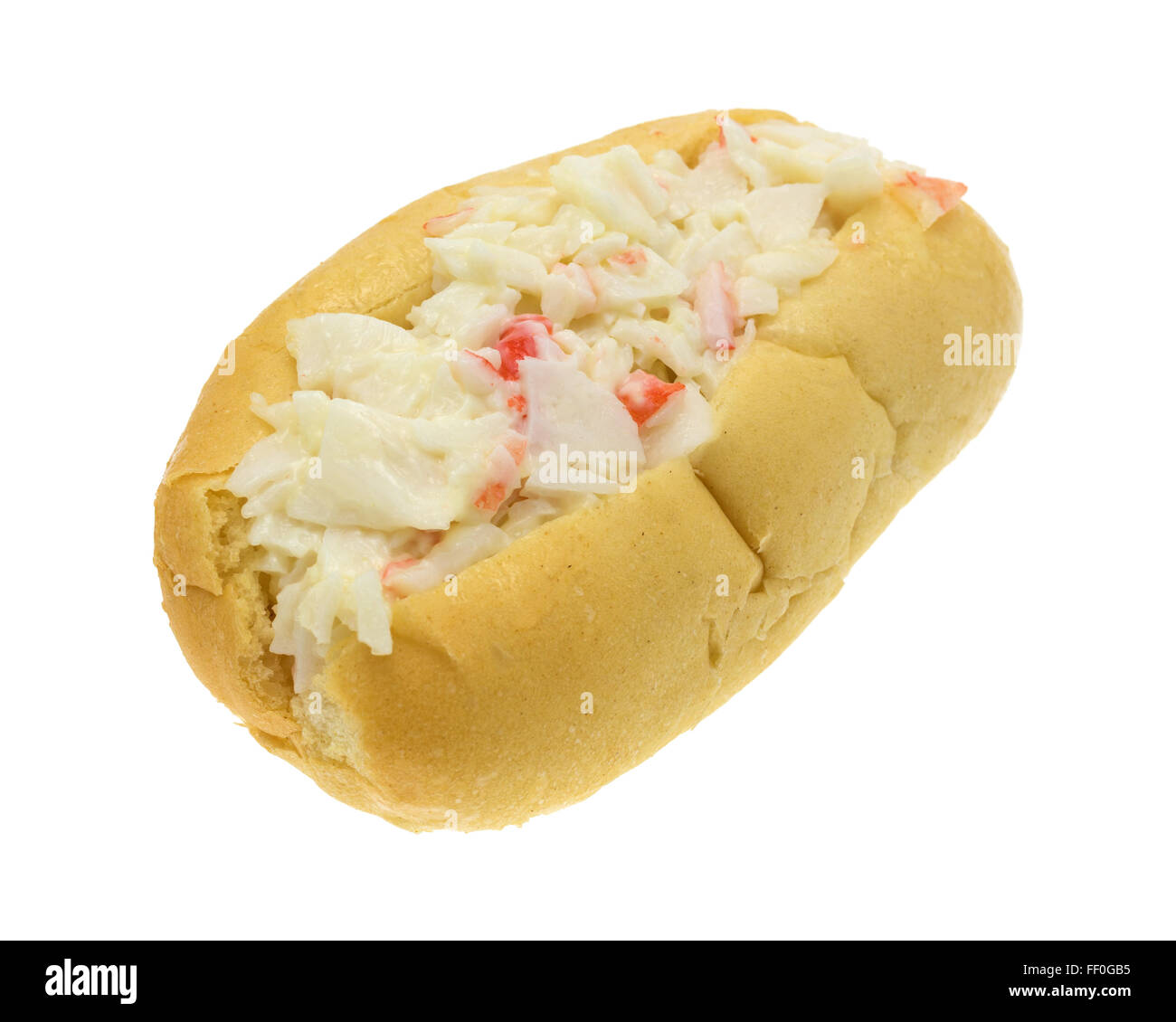 A surimi crab meat made into a salad with mayonnaise on a small sub roll isolated on a white background. Stock Photo