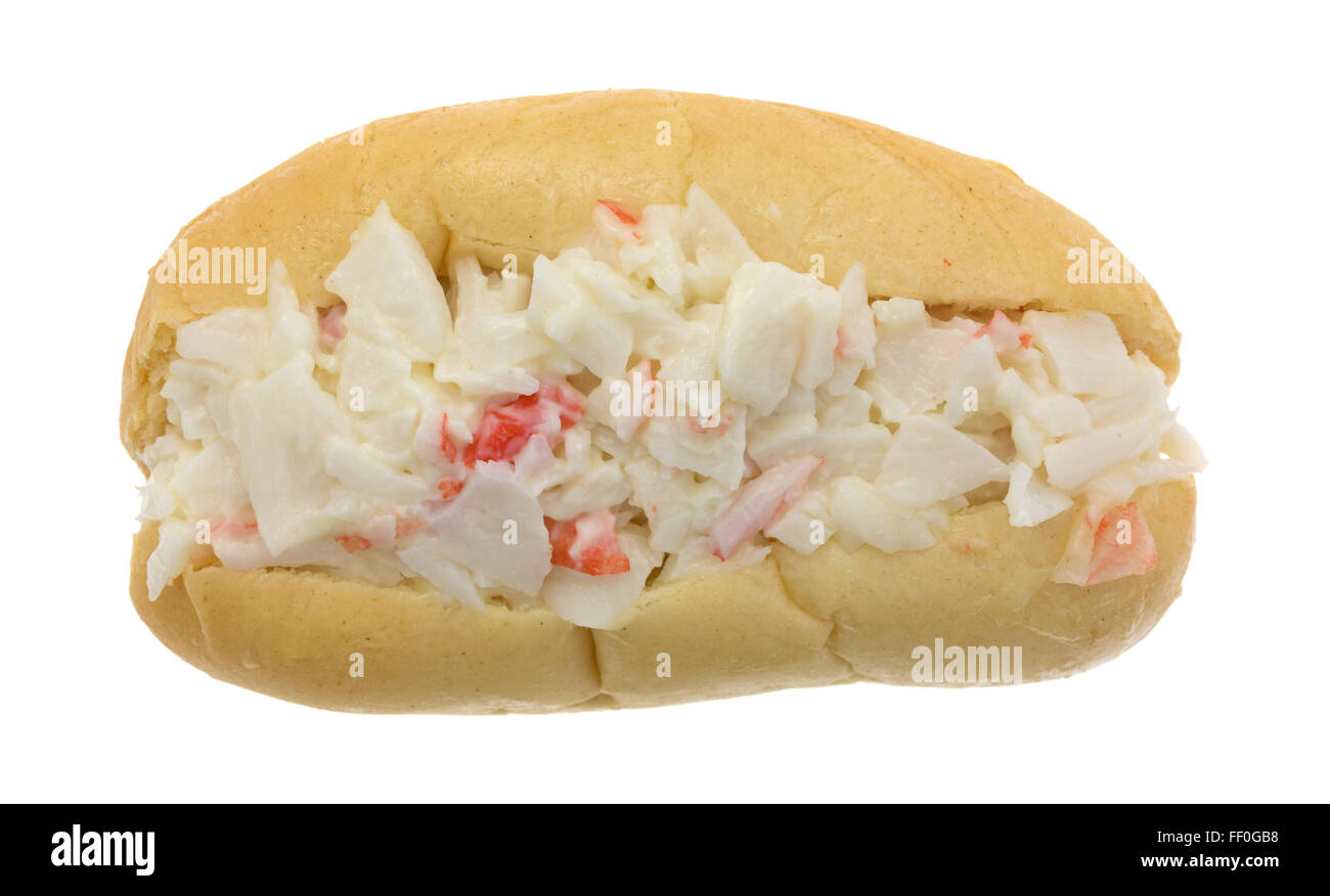 Top view of a surimi crab meat made into a salad with mayonnaise on a small sub roll isolated on a white background. Stock Photo