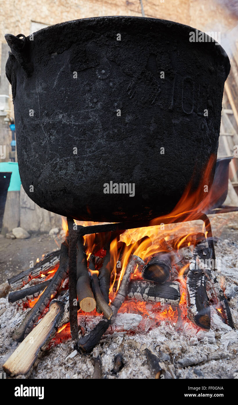Big cast iron pot boiling water outdoor in the countryside Stock Photo