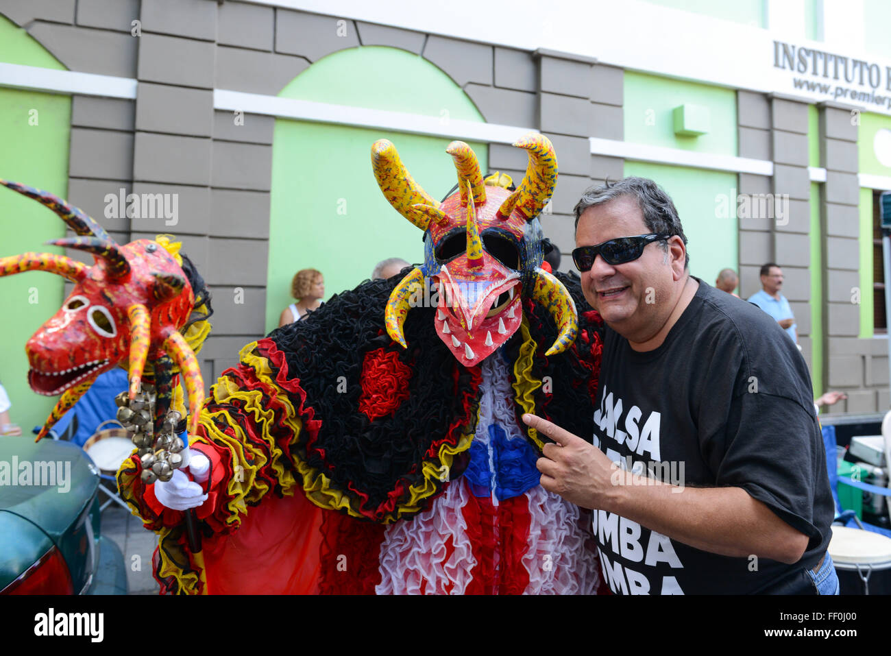 Traditional masked cultural figure VEJIGANTE posing with people during carnival. Ponce, Puerto Rico. February 2016 Stock Photo