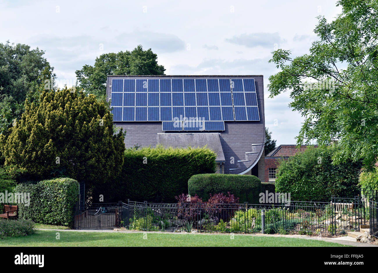 Solar panels on roof of Muswell Hill Methodist Church with garden in front, London Borough of Haringey England Britain UK Stock Photo