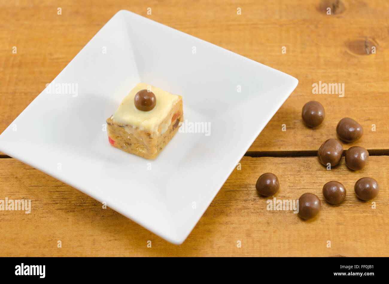 dessert with chocolate ball on top in a white plate Stock Photo