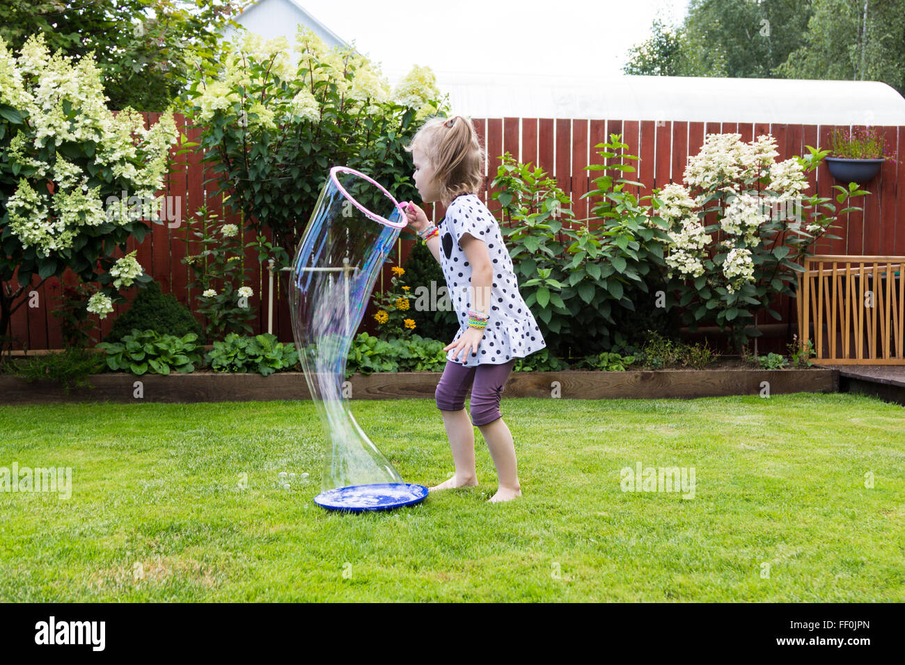 girl playing with soap bubbles in a beautiful garden Stock Photo - Alamy